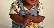 Moneii James joined the competition — help win amazing prizes! baby, child, smile, overalls, braided_hair, cupcake, candle, celebration, birthday, sitting, cute, happy, studio, photography, toy, clothing, foot, face, infant, background