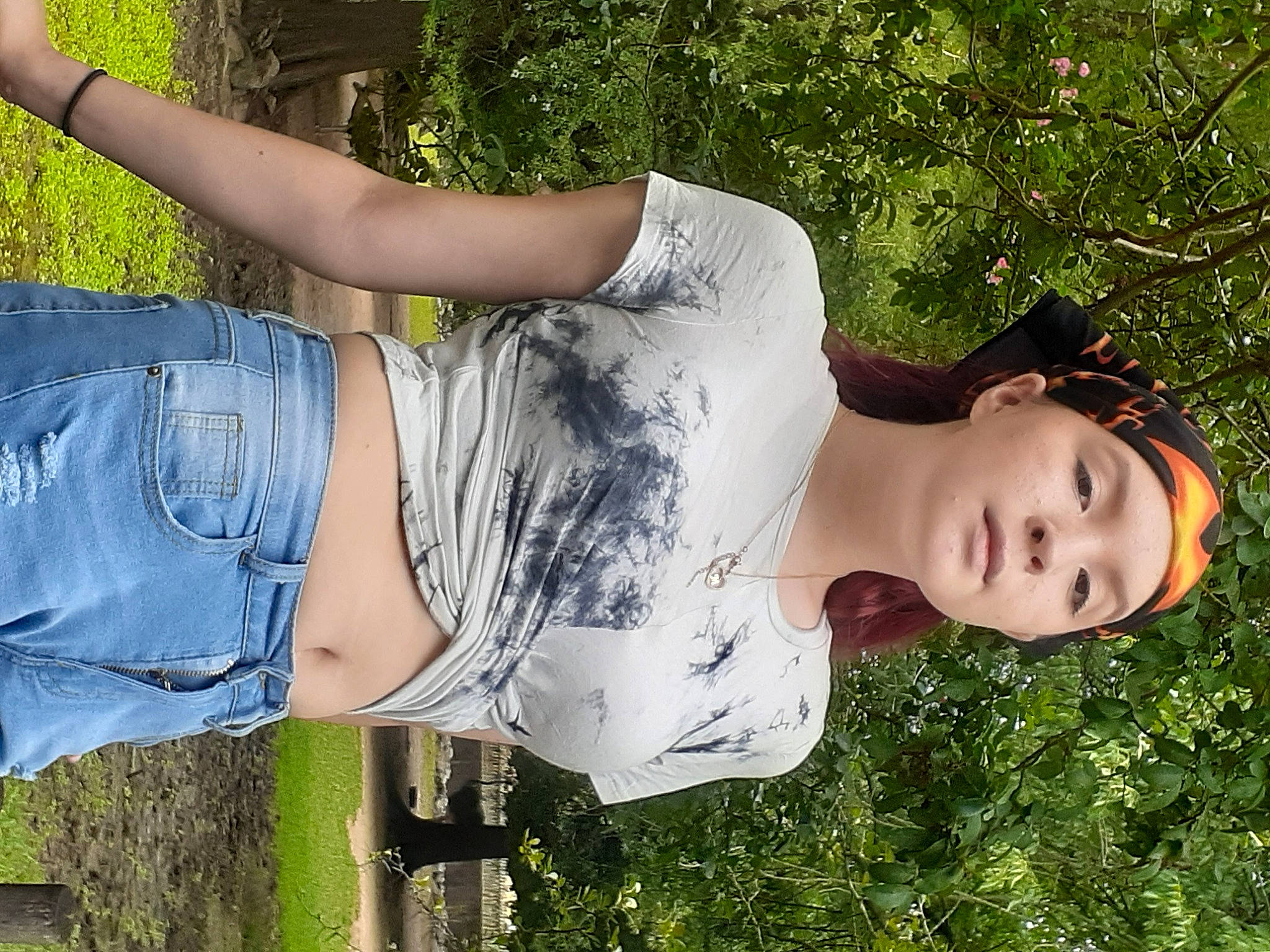 Brianna joined the competition — help win amazing prizes! beauty, black_hair, clothing, cool, fun, grass, happy, headwear, joint, leisure, long_hair, people_in_nature, person, plant, shoulder, street_fashion, sunlight, textile, thigh, tree