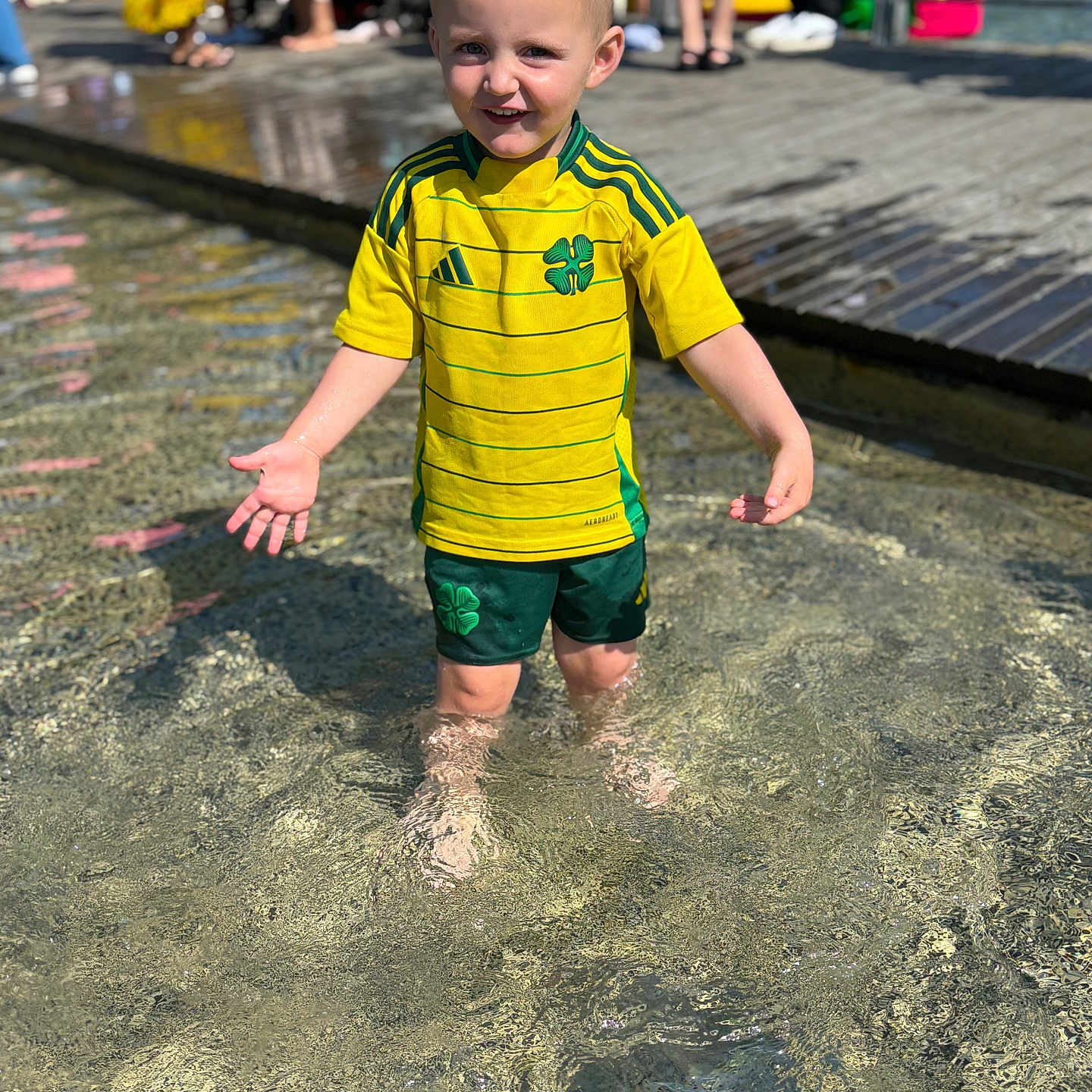 Jack-junior joined the competition — help win amazing prizes! background, boy, casual_clothing, child, daylight, green_shorts, happy, legs, outdoor, people, playful, public_space, reflection, smiling, sportswear, summer, sunlight, water, water_splash, yellow_shirt