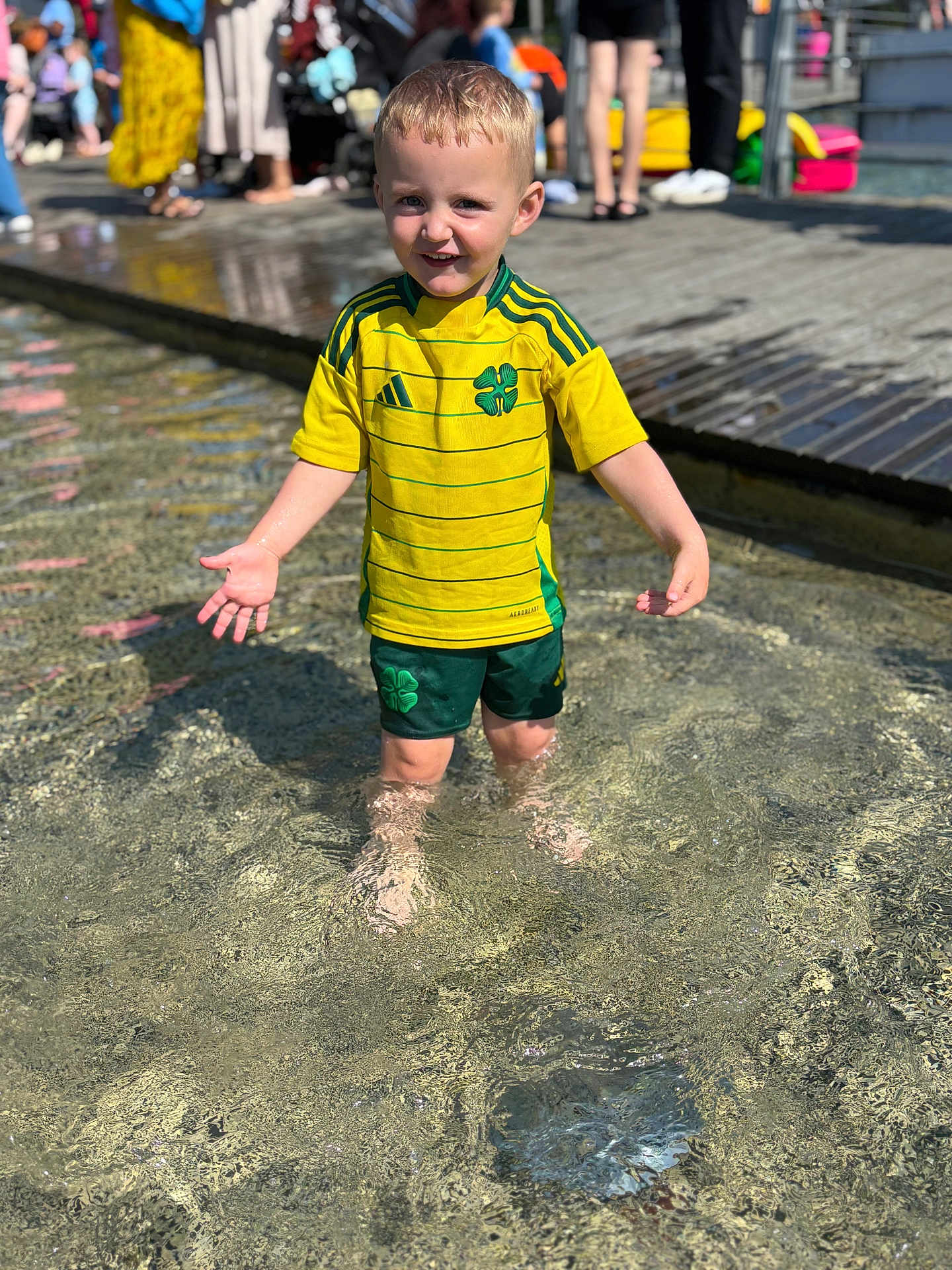 Jack-junior joined the competition — help win amazing prizes! child, boy, water, outdoor, summer, yellow_shirt, green_shorts, sportswear, sunlight, reflection, happy, smiling, people, background, legs, water_splash, playful, daylight, casual_clothing, public_space