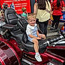 Jack-junior joined the competition — help win amazing prizes! child, boy, motorcycle, goldwing, vehicle, street, people, red, sign, pharmacy, smile, casual_clothing, urban, outdoor, footwear, hair, person, waiting, conversation, background