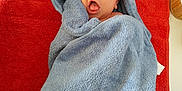 Ethan a rejoint le concours — aidez-le/la à gagner de superbes lots ! baby, child, towel, blue_towel, red_towel, hood, face, expression, mouth_open, eyes, skin, person, infant, lying_down, indoor, soft_texture, cute, cozy, wrapped, hand