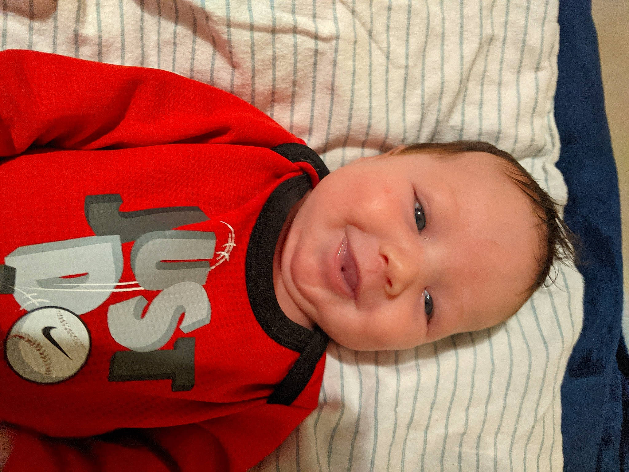 Jerome is registered to the contest to win money with this photo: baby, baby_sleeping, baby_toddler_clothing, carmine, cheek, child, comfort, fictional_character, happy, laugh, mouth, nose, person, plant, sleeve, smile, textile, toddler, tree, vertebrate