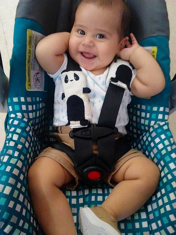 Thiago is registered to the contest to win money with this photo: arm, baby, baby_in_car_seat, baby_products, car_seat, child, finger, leg, pattern, person, product, sitting, thigh, toddler