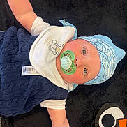 Mateo joined the competition — help win amazing prizes! arm, baby, black_blanket, blue_bandana, child, clothing, cute, eyes, face, headwear, indoors, infant, lying_down, mouth, navy_vest, pacifier, person, portrait, skin, white_shirt
