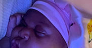 Sariyah joined the competition — help win amazing prizes! baby, sleeping, pink_hat, blanket, hand, face, child, cute, indoors, cozy, soft_lighting, peaceful, chubby_cheeks, wrapped, portrait, headwear, toddler, comfort, resting, bed