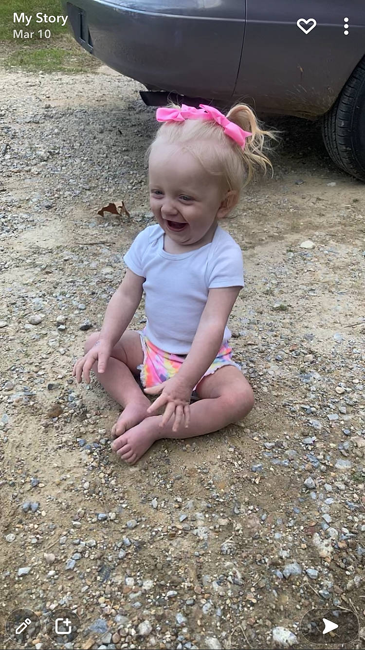 Kendal is registered to the contest to win money with this photo: automotive_tire, body_of_water, fun, grass, hairstyle, happy, leaf, mammal, mouth, people, people_in_nature, person, pink, sand, skin, smile, summer, tire, toddler, vertebrate