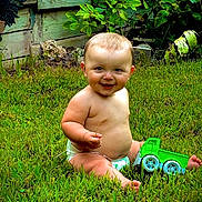 Xzavier is registered to the contest to win money with this photo: baby, barefoot, child, childhood, diaper, garden, garden_plants, grass, green_toy, happy, infant, nature, outdoor, playtime, portrait, sitting, smiling, summer, toy_truck, wooden_fence