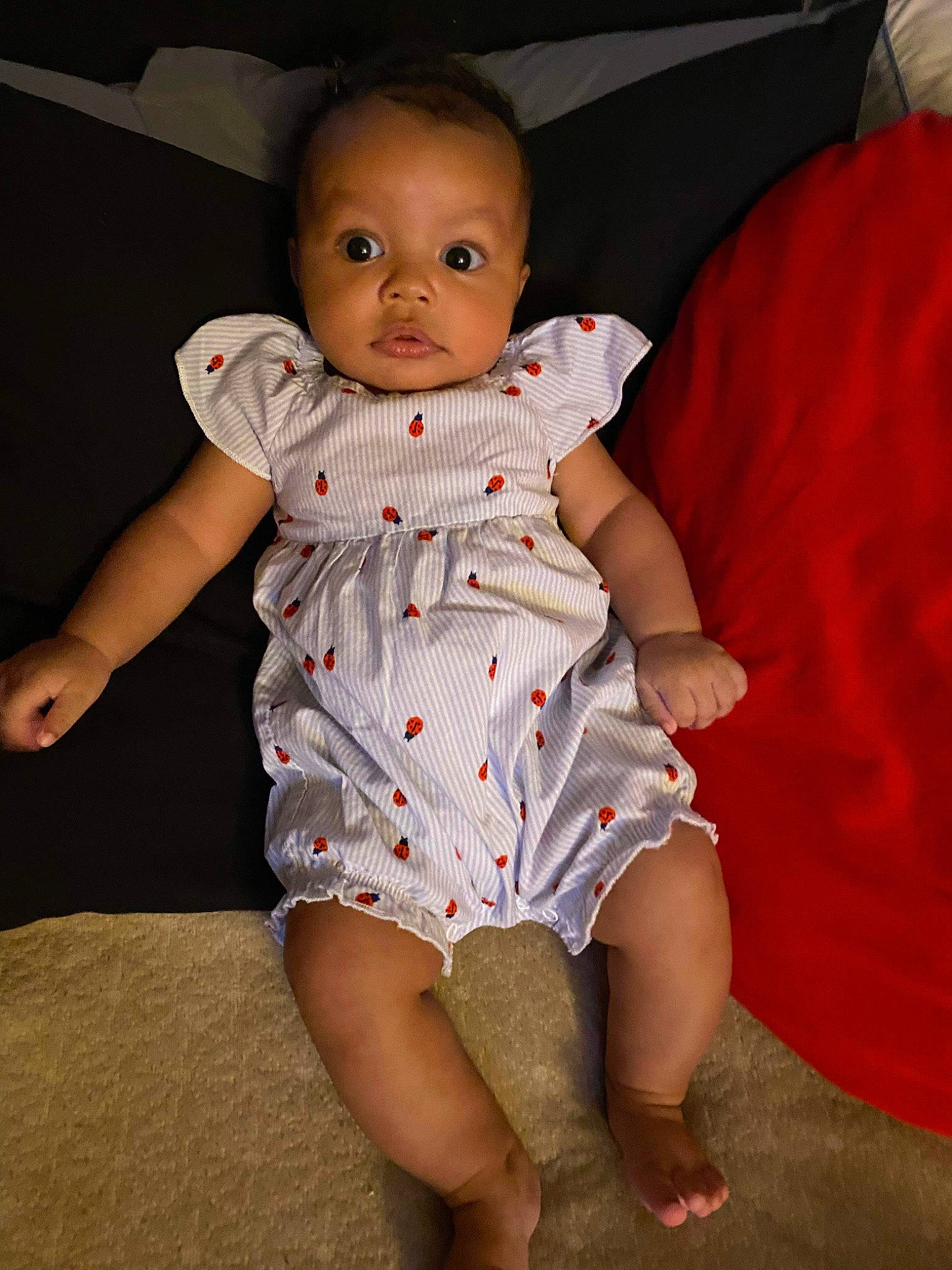 Kaydance is registered to the contest to win money with this photo: baby, baby_toddler_clothing, child, comfort, day_dress, dress, face, finger, flash_photography, foot, fun, head, human_leg, one_piece_garment, pattern, person, sitting, skin, sleeve, thigh