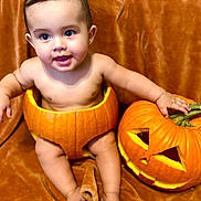 Eric is registered to the contest to win money with this photo: baby, child, pumpkin, carved_pumpkin, halloween, orange, cute, smiling, face, skin, sitting, holiday, festive, background, cheerful, indoors, autumn, decoration, playful, costume