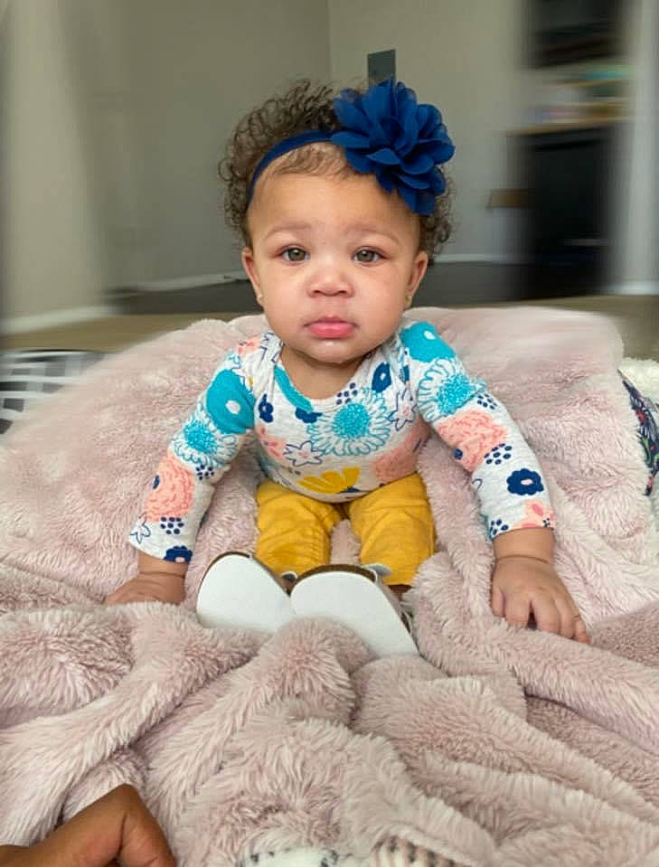 Alaiya is registered to the contest to win money with this photo: baby, baby_toddler_clothing, cheek, child, eye, face, flooring, fun, happy, head, linens, pattern, person, pink, portrait_photography, sitting, skin, sleeve, smile, t_shirt