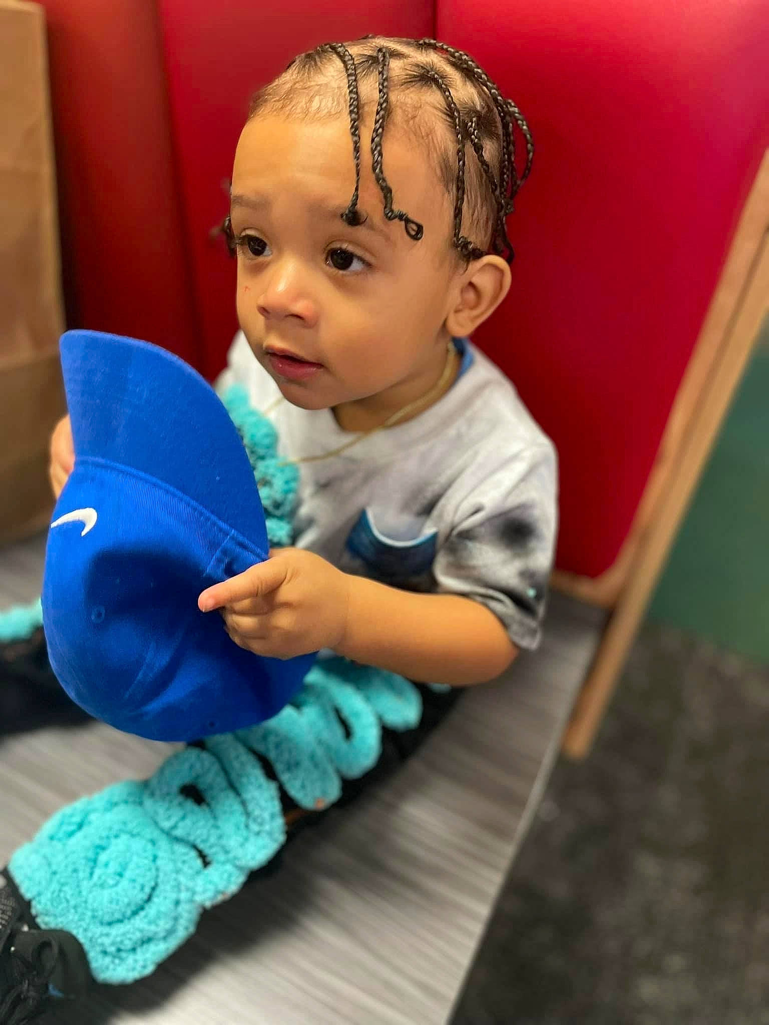 Messiah is registered to the contest to win money with this photo: arm, baby, baby_playing_with_toys, baby_toddler_clothing, child, comfort, electric_blue, finger, flooring, fun, hand, happy, human_body, person, sitting, skin, sock, t_shirt, thumb, toddler