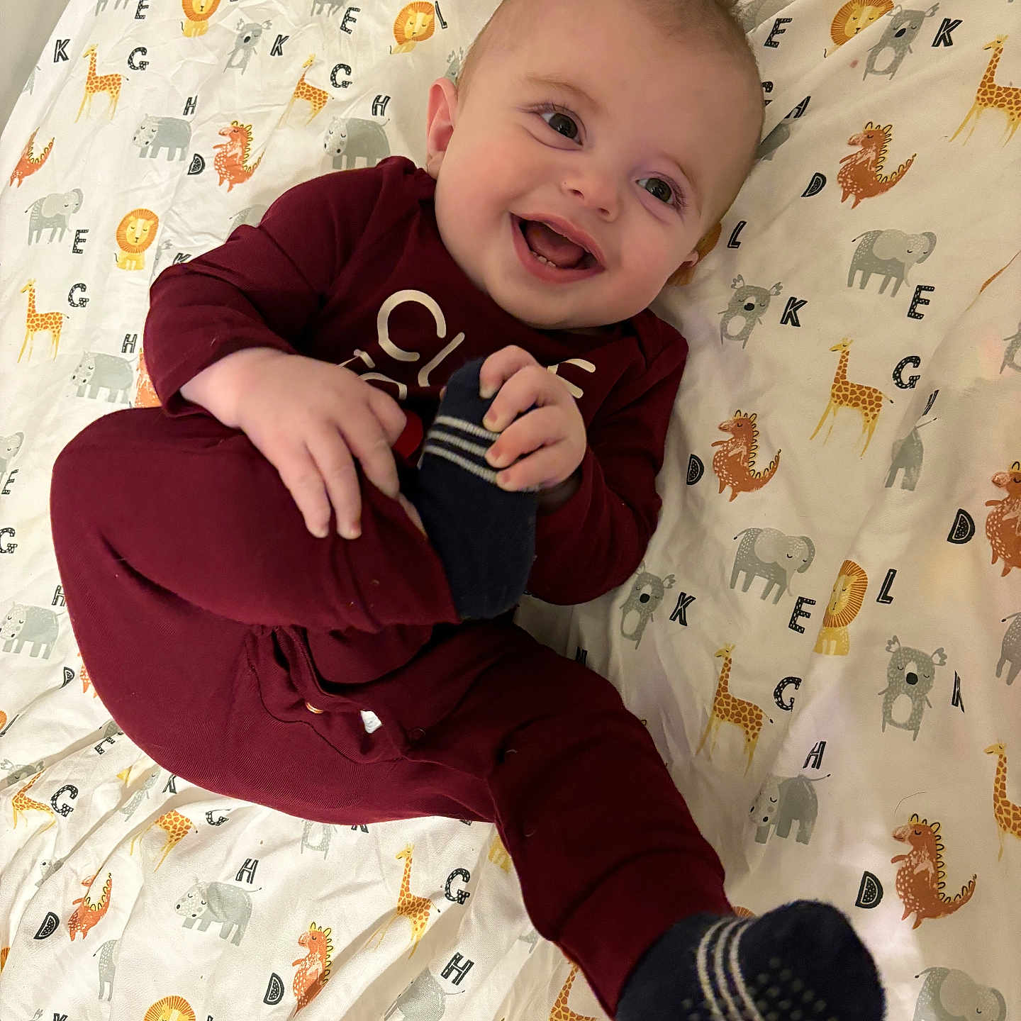 Camden joined the competition — help win amazing prizes! baby, babylaughing, bed, blanket, bodypart, clothing, face, finger, furniture, glove, hand, happy, head, laughing, pants, person, photography, portrait, sitting, smile