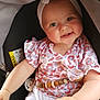 Margot participe au concours pour gagner de l'argent avec cette photo : baby, car_seat, headband, smiling, child, infant, clothing, seatbelt, patterned_shirt, white_pants, hand, cute, adorable, indoor, safety, baby_toy, beads, face, person, seat