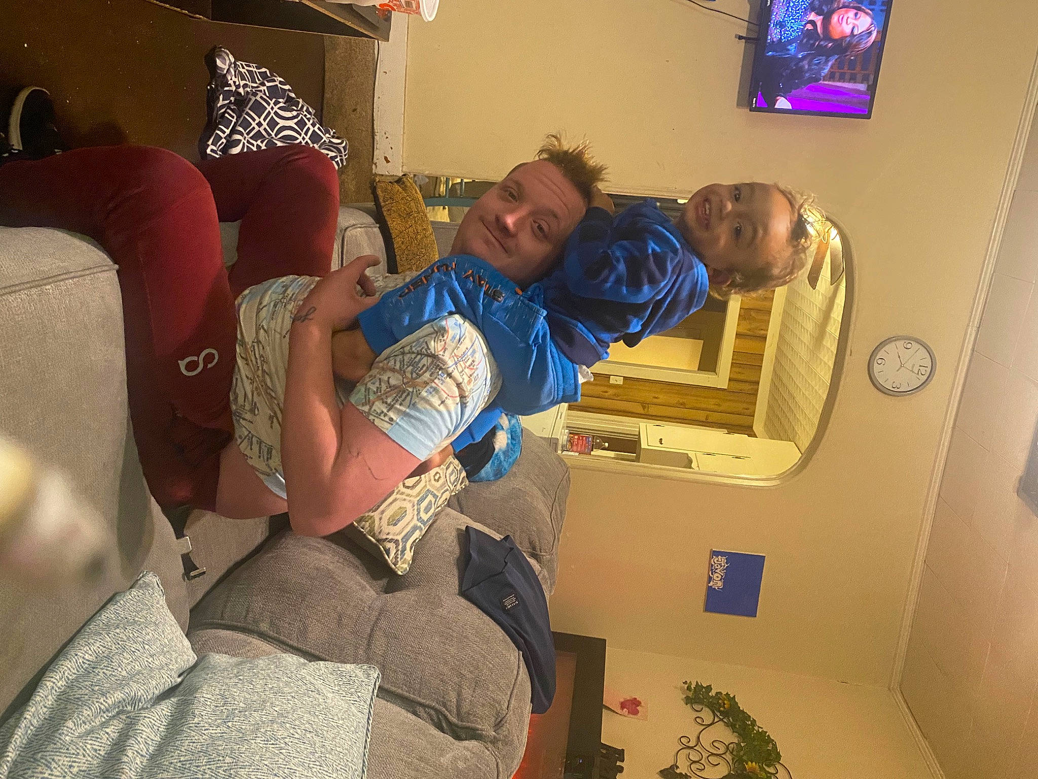 Javon is registered to the contest to win money with this photo: abdomen, baby, chair, comfort, couch, elbow, event, fun, house, interior_design, joy, living_room, person, picture_frame, plant, room, shoulder, sitting, smile, t_shirt