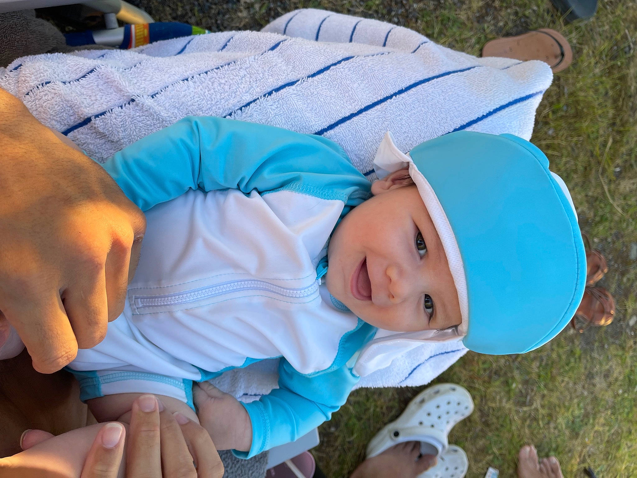 Jeraiya is registered to the contest to win money with this photo: azure, baby, baby_toddler_clothing, blue, child, comfort, couch, electric_blue, fun, grass, happy, hat, headwear, human_body, lap, leisure, person, recreation, sitting, smile