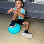 Jayden Noah is registered to the contest to win money with this photo: adult, ball, balloon, boy, child, clothing, couch, face, football, footwear, furniture, head, male, man, person, photography, portrait, shoe, shorts, sitting