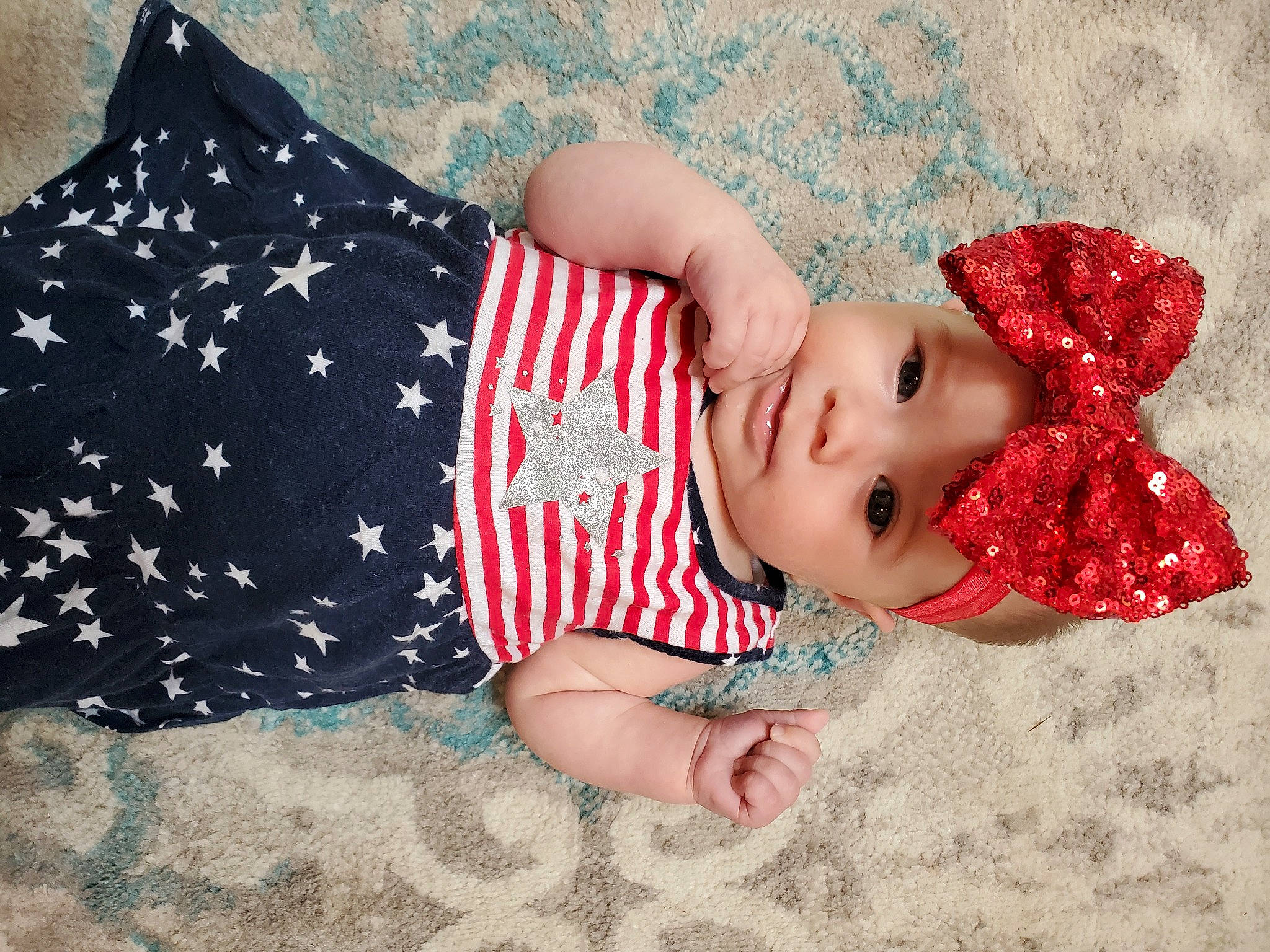 Lorelai is registered to the contest to win money with this photo: baby, baby_toddler_clothing, carmine, child, clothing, doll, dress, eye, grass, happy, hat, head, headgear, headwear, human_body, linens, lip, pattern, person, sleeve