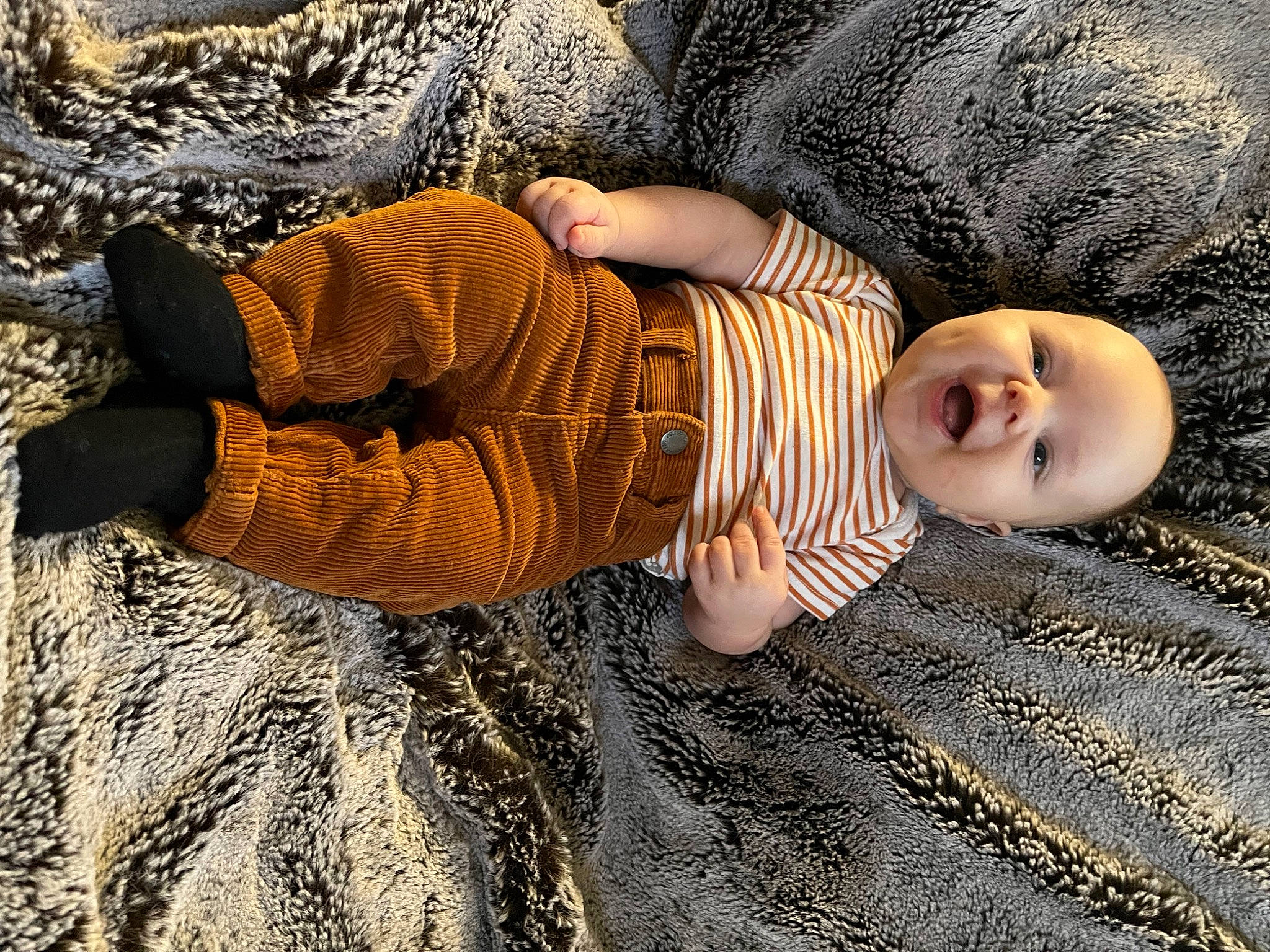 Maxwell is registered to the contest to win money with this photo: baby, baby_toddler_clothing, child, comfort, eye, flooring, fur, grass, head, human_body, human_leg, linens, pattern, people_in_nature, person, sleeve, soil, toddler, tree, wood