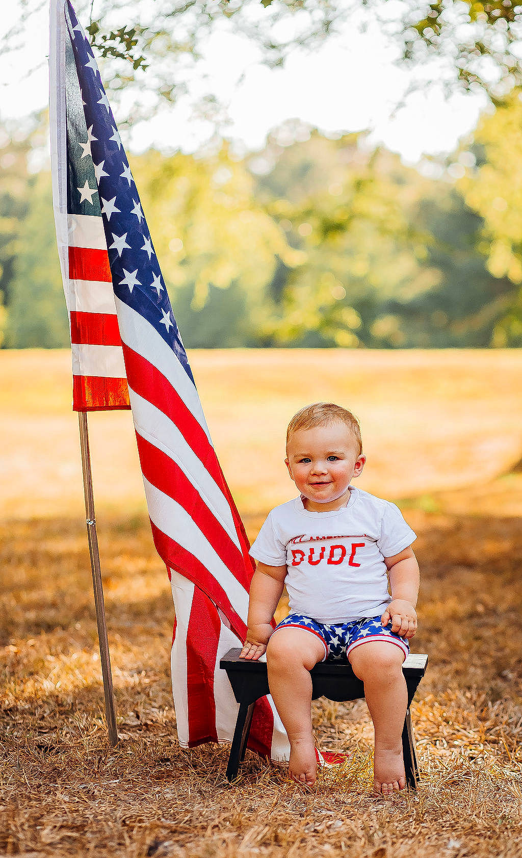 Keaton joined the competition — help win amazing prizes! child, flag, flag_of_the_united_states, fun, grass, grassland, happy, joy, landscape, leaf, leisure, people_in_nature, person, recreation, shorts, sitting, soil, spring, sunlight, t_shirt