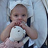 Michelle is registered to the contest to win money with this photo: baby, child, stroller, teddy_bear, stuffed_toy, bow, headband, infant, cute, soft_toy, white, pink, clothing, seat_belt, baby_carrier, portrait, outdoor, baby_girl, toy, person