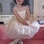 Hana joined the competition — help win amazing prizes! child, girl, toddler, portrait, smiling, happy, dress, princess_dress, hair_bow, seated, indoor, playroom, playpen, pink_couch, shoes, sparkly, fashion, looking_at_camera, cute, photography