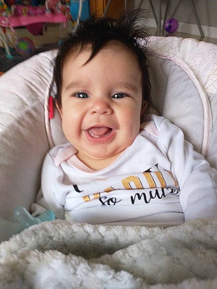 Sofia is registered to the contest to win money with this photo: baby, baby_toddler_clothing, cheek, child, comfort, ear, eyelash, finger, fun, happy, joy, linens, mouth, nose, person, product, room, sitting, skin, sleeve