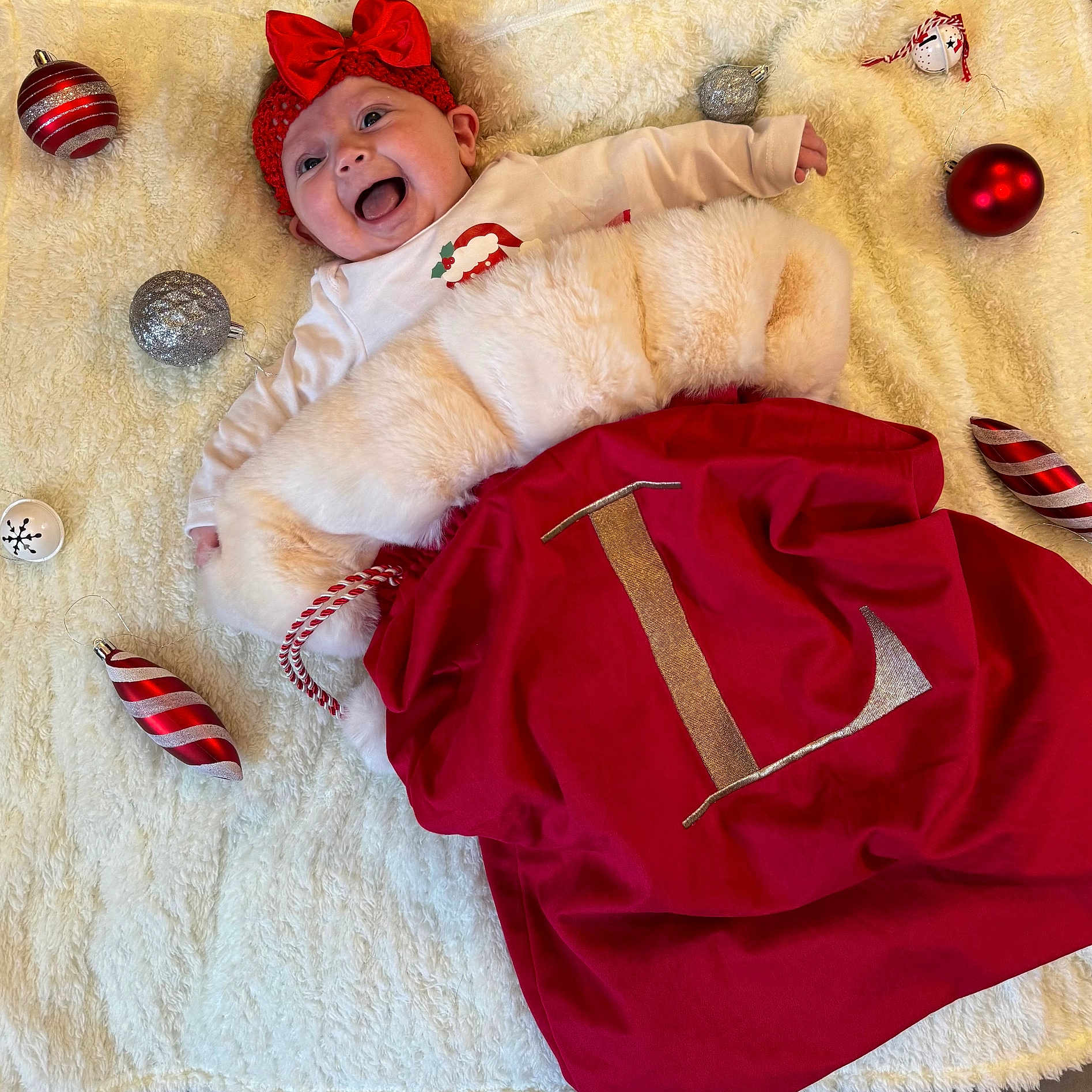Lottie is registered to the contest to win money with this photo: baby, ball, blanket, clothing, coat, costume, cricket, cricketball, dress, face, football, furniture, glove, hat, head, jacket, person, photography, portrait, sport