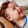 Samuel a rejoint le concours — aidez-le/la à gagner de superbes lots ! child, toddler, smiling, curly_hair, face, blanket, cozy, texture, happy, closeup, portrait, indoor, couch, clothing, casual, expression, young, person, cute, relaxed