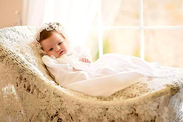 Mckenna is registered to the contest to win money with this photo: baby, baby_toddler_clothing, bedding, bridal_accessory, comfort, dress, embellishment, event, fashion_accessory, flash_photography, grass, hair_accessory, happy, headgear, headpiece, linens, person, sitting, sleeve, toddler