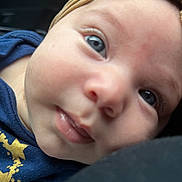 Emily joined the competition — help win amazing prizes! baby, closeup, face, blue_eyes, headband, curious, infant, skin, mouth, nose, clothing, navy_blue, gold, star, expression, person, portrait, cute, young, child