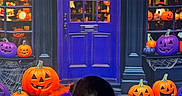 Lakota Skye is registered to the contest to win money with this photo: dog, border_collie, black_and_white, pet, animal, halloween, pumpkins, jack_o_lanterns, spooky, costume, tulle, orange, purple, shopfront, door, window, cobwebs, indoor, portrait, tongue_out
