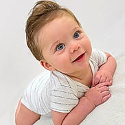 Randy joined the competition — help win amazing prizes! baby, infant, smiling, cute, blue_eyes, white_clothing, lying_down, soft_texture, portrait, child, happy, skin, hair, small_hands, head, face, looking_up, indoors, young, one_person