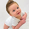 baby, infant, smiling, cute, blue_eyes, white_clothing, lying_down, soft_texture, portrait, child, happy, skin, hair, small_hands, head, face, looking_up, indoors, young, one_person