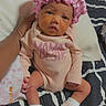 newborn, baby, infant, child, portrait, pink_bonnet, onesie, baby_clothes, socks, blanket, pillow, bed, bedroom, hand, adult_hand, sitting, sleepy, face, indoors, photography