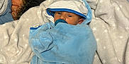 Asher joined the competition — help win amazing prizes! baby, bedroom, blanket, blue, clothing, comfort, cute, fabric, face, hood, infant, lying_down, newborn, pacifier, resting, soft, stars, warm, white, wrapped