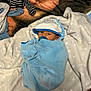 baby, bedroom, blanket, blue, clothing, comfort, cute, fabric, face, hood, infant, lying_down, newborn, pacifier, resting, soft, stars, warm, white, wrapped