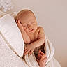 newborn, baby, sleeping, blanket, pillow, soft_texture, peaceful, relaxation, infant, skin, wrapped, rest, cozy, portrait, cute, small_hands, small_feet, indoors, warm_colors, calm