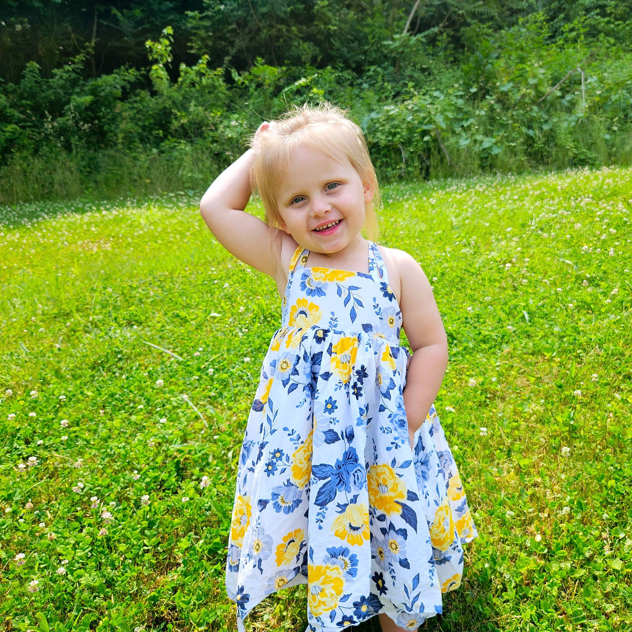 Corinne is registered to the contest to win money with this photo: baby_toddler_clothing, day_dress, flower, grass, grass_family, grassland, green, groundcover, happy, joy, meadow, nature, one_piece_garment, people_in_nature, person, plant, prairie, sleeve, smile, summer