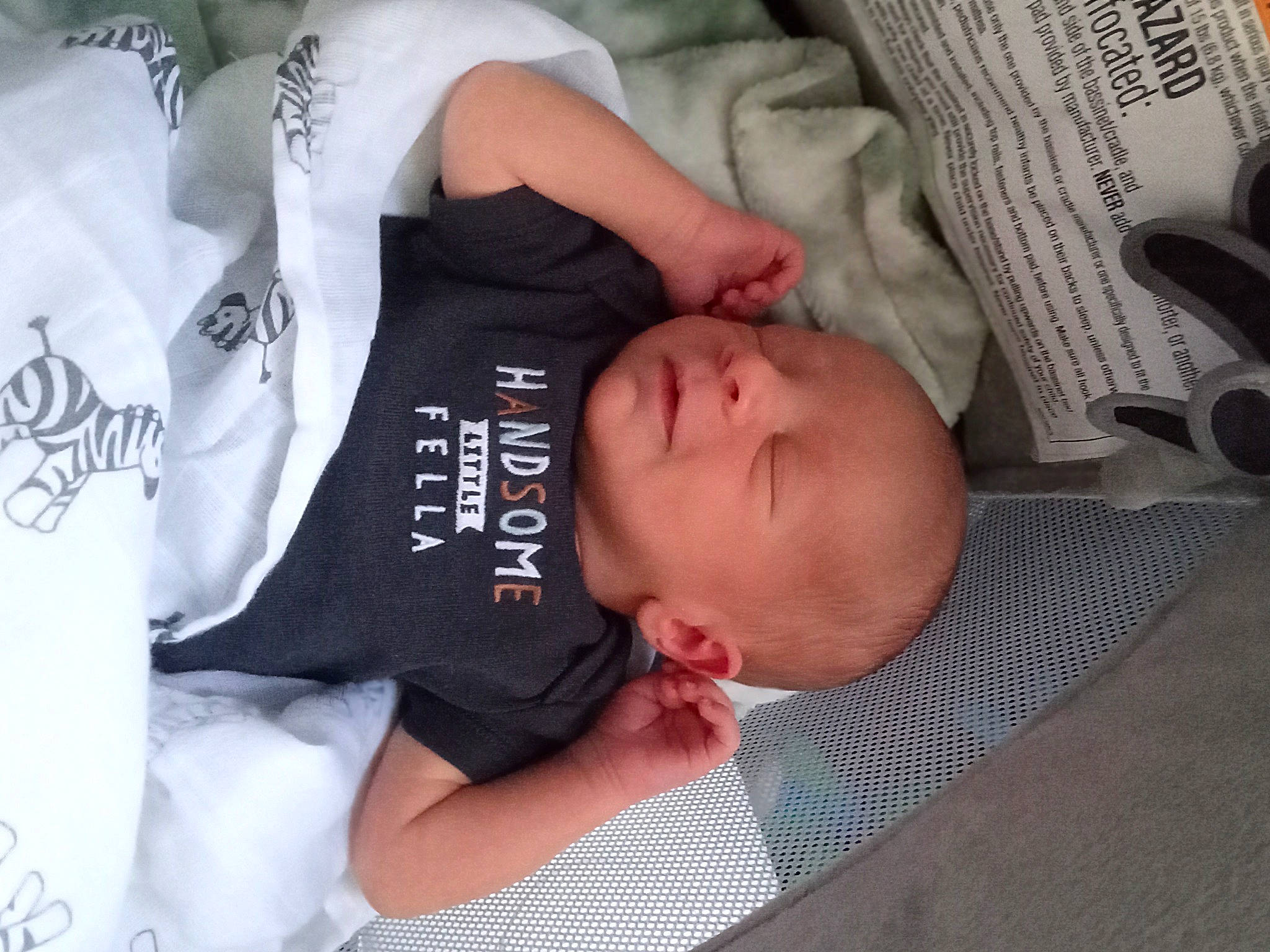 Blayne is registered to the contest to win money with this photo: baby, baby_toddler_clothing, child, comfort, elbow, finger, flesh, font, linens, musical_instrument, nail, nap, newspaper, pattern, person, product, sitting, sleeve, t_shirt, toddler