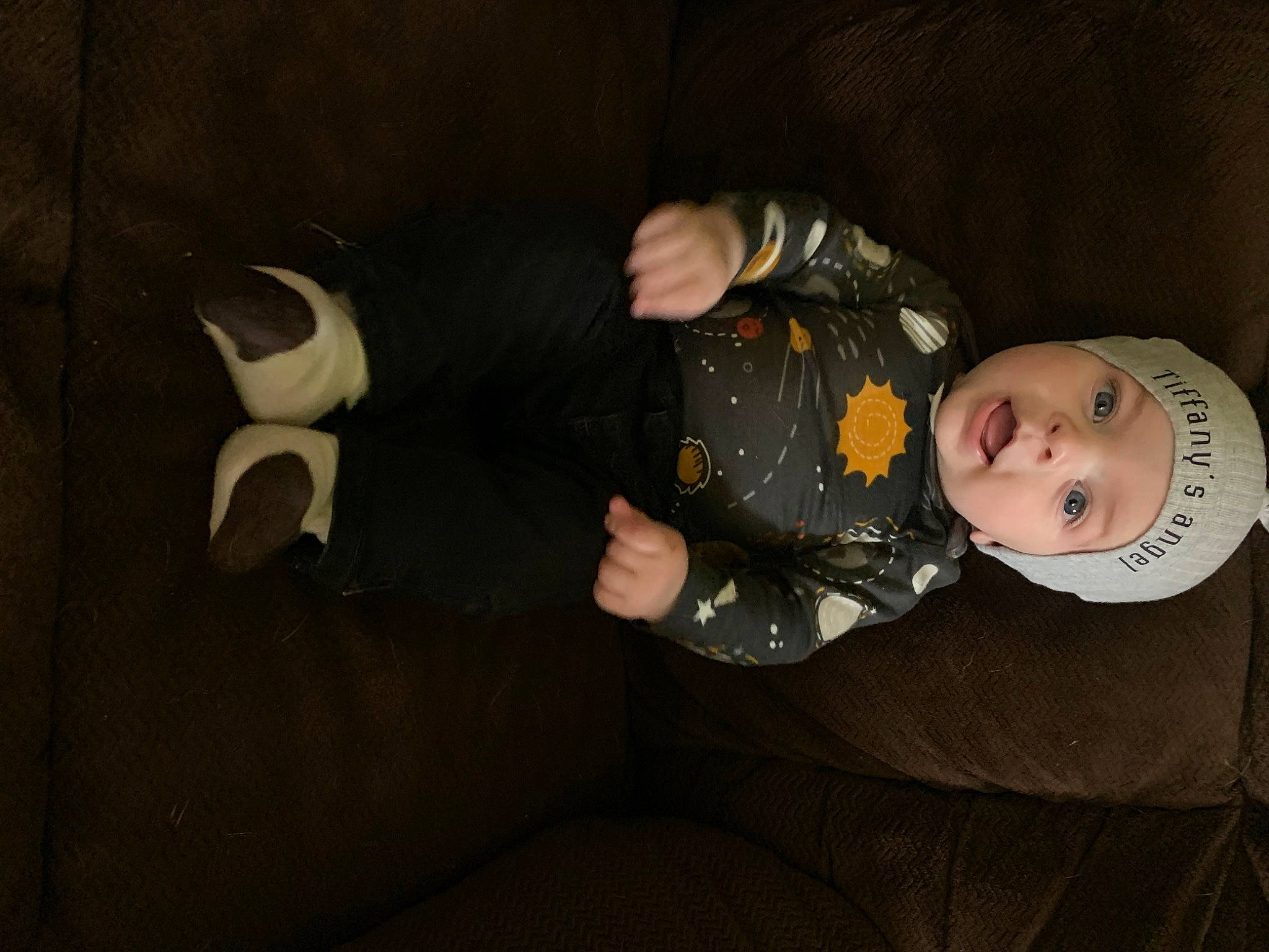 Colton is registered to the contest to win money with this photo: audio_equipment, baby, baby_toddler_clothing, child, comfort, costume_hat, darkness, flash_photography, formal_wear, fun, gesture, hat, headwear, person, personal_protective_equipment, room, sitting, sleeve, suit, toddler