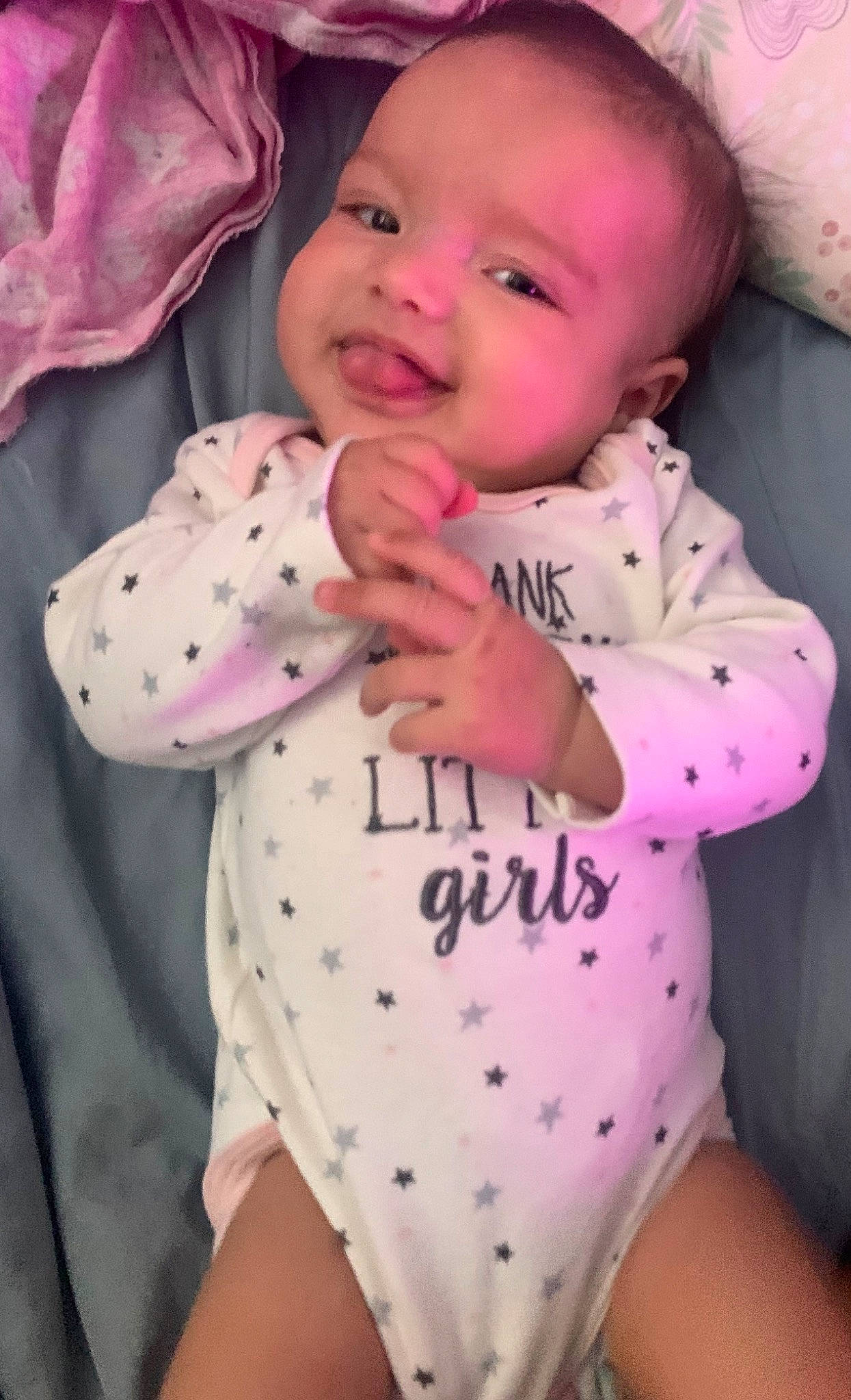 Naylani is registered to the contest to win money with this photo: arm, baby, baby_toddler_clothing, cheek, comfort, face, facial_expression, finger, hand, happy, lip, nose, person, pink, skin, sleeve, smile, thigh, thumb, toddler