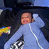 Jasai is registered to the contest to win money with this photo: baby, bed, blanket, child, comfortable, cozy, cute, happy, indoor, infant, lying_down, person, portrait, relaxed, sleepwear, smiling, snack_box, striped_clothing, toddler, young