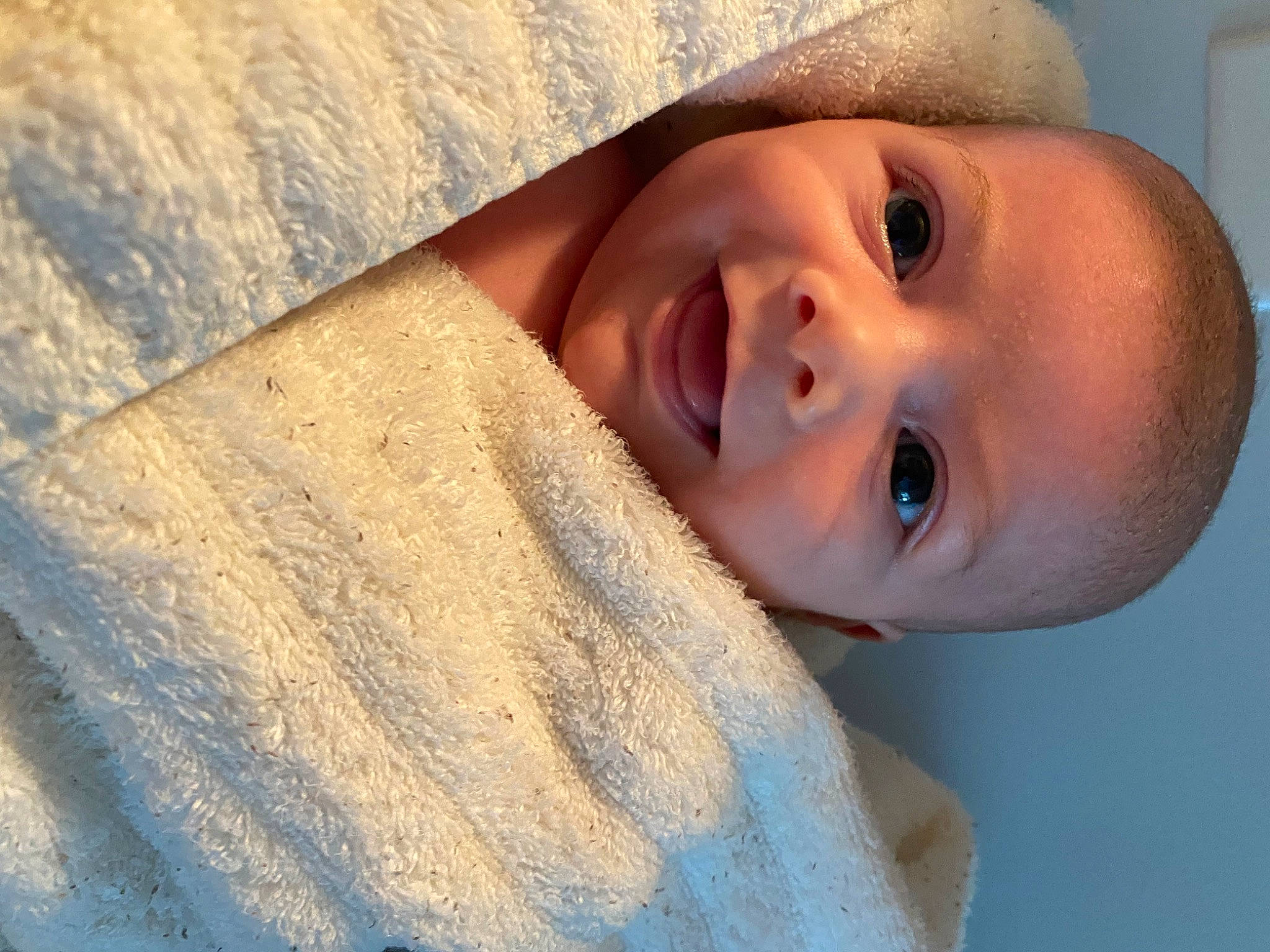 David is registered to the contest to win money with this photo: baby, cheek, child, comfort, eyelash, flash_photography, fur, happy, iris, linens, lip, neck, nose, person, portrait_photography, skin, sleeve, smile, toddler, wood