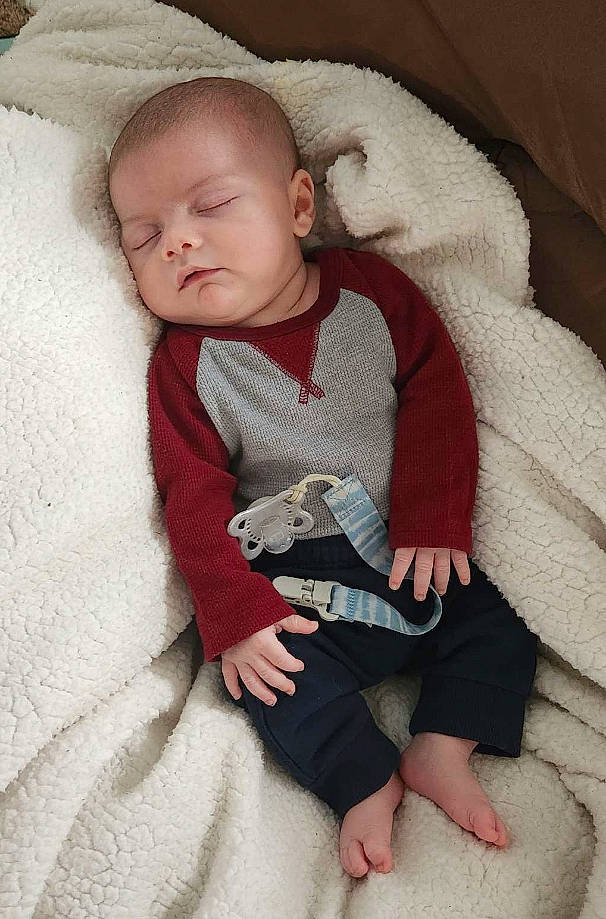 David joined the competition — help win amazing prizes! baby, baby_toddler_clothing, cheek, comfort, eye, face, finger, foot, head, human_body, lap, linens, nose, person, sitting, skin, sleeve, textile, toddler, wood