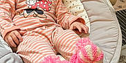 Eden participe au concours pour gagner de l'argent avec cette photo : baby, baby_rocker, blanket, child, comfort, cozy, cute, face, home, indoor, infant, knitted, pajamas, pink_booties, relaxed, seated, smile, soft, striped_clothing, toy
