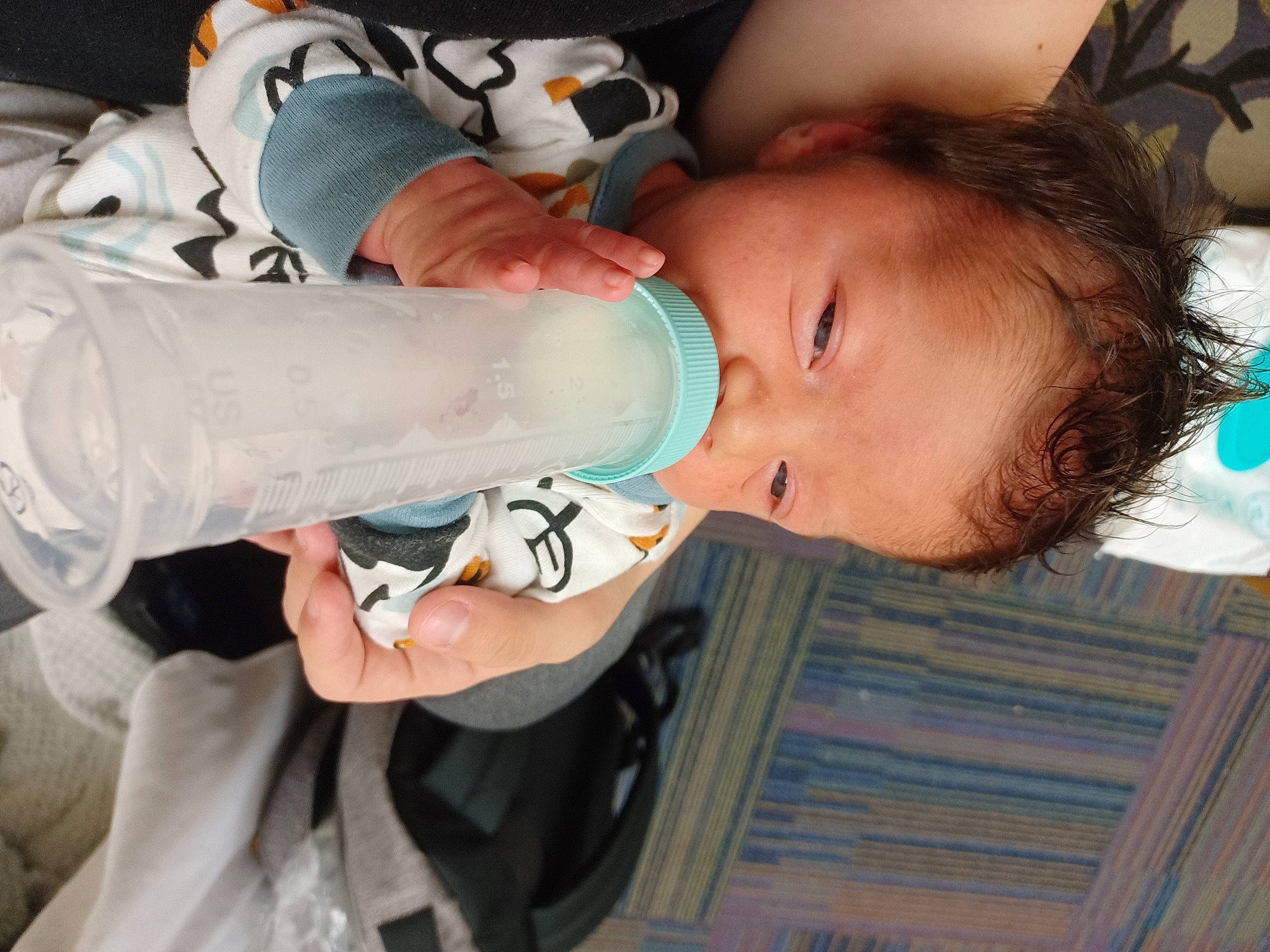 Connor is registered to the contest to win money with this photo: baby, baby_bottle, baby_products, baby_toddler_clothing, child, drink, drinking, drinkware, eyelash, happy, human_body, milk, mouth, nail, person, personal_protective_equipment, plastic, plastic_bottle, sleeve, toddler