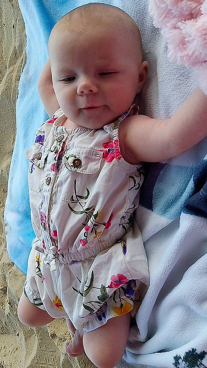 Izabella is registered to the contest to win money with this photo: baby, baby_toddler_clothing, cheek, child, chin, collar, comfort, eye, face, grass, happy, iris, linens, lip, neck, person, pink, skin, sleeve, textile