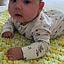 Lilah is registered to the contest to win money with this photo: baby, blanket, bodypart, couch, crawling, crib, cushion, face, finger, furniture, hand, head, homedecor, infantbed, newborn, person, photography, portrait, quilt, sitting