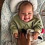 Lilah joined the competition — help win amazing prizes! baby, babylaughing, bodypart, clothing, crib, cushion, face, finger, furniture, hand, happy, hat, head, homedecor, infantbed, newborn, person, photography, portrait, smile